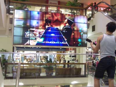 Boy Playing Video Game on Commercial Display